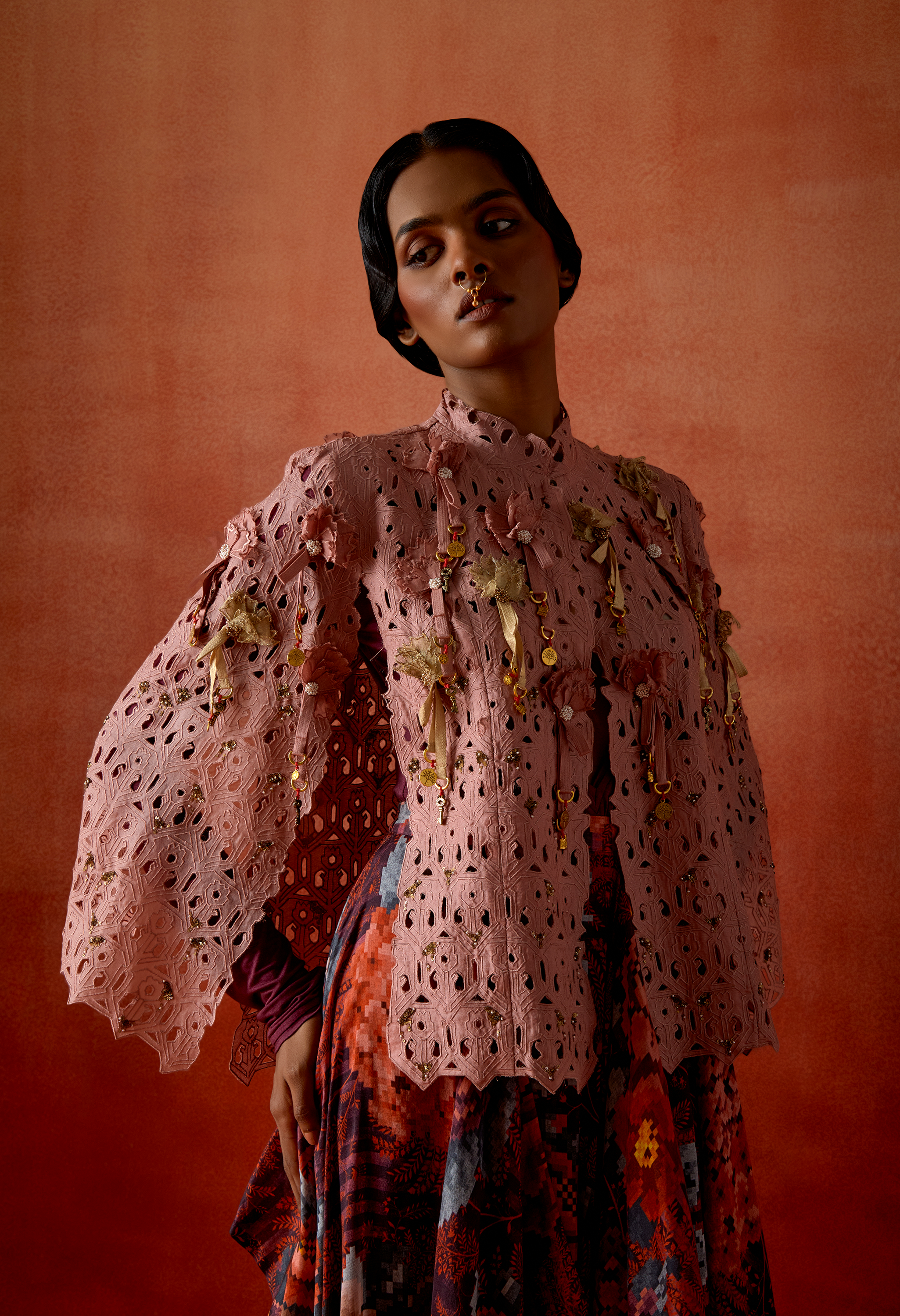 CUTWORK CAPE WITH DRAPED SKIRT